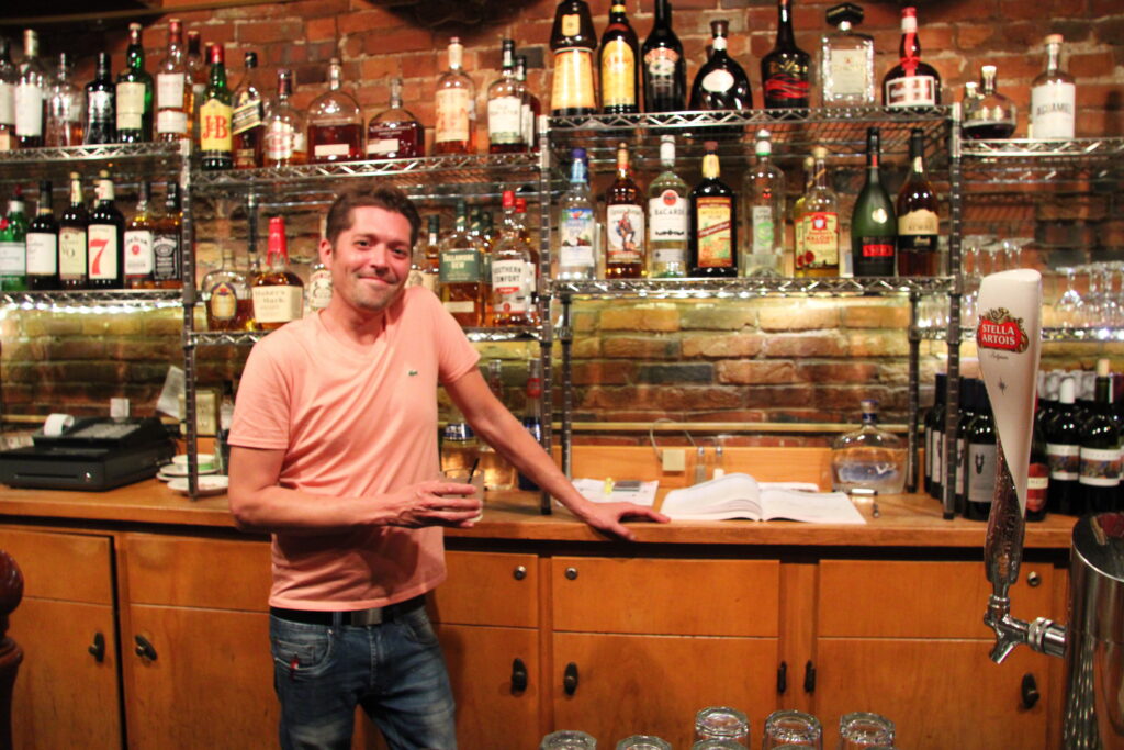 Carl standing behind the bar at Robbie Bar & Grill